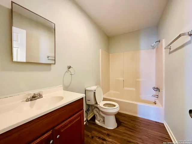 a bathroom with a sink toilet a mirror and shower