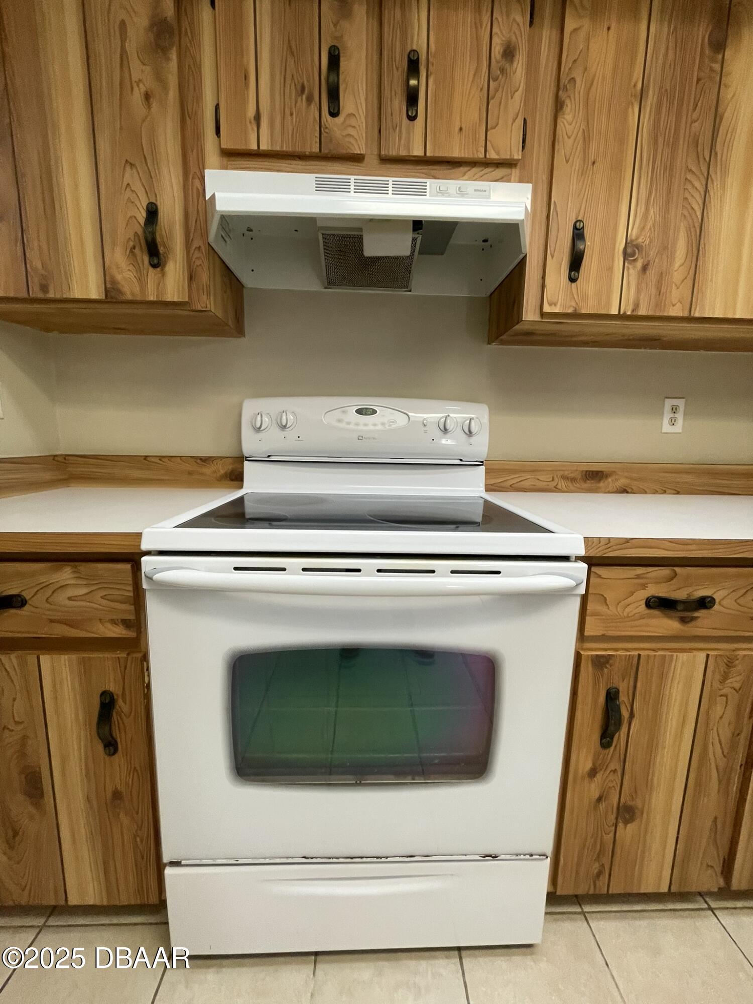 112 Tomoka Meadows Boulevard Ormond Beach, FL 32174 - Photo 12 of 53 a stove top oven sitting inside of a kitchen with granite countertop cabinets