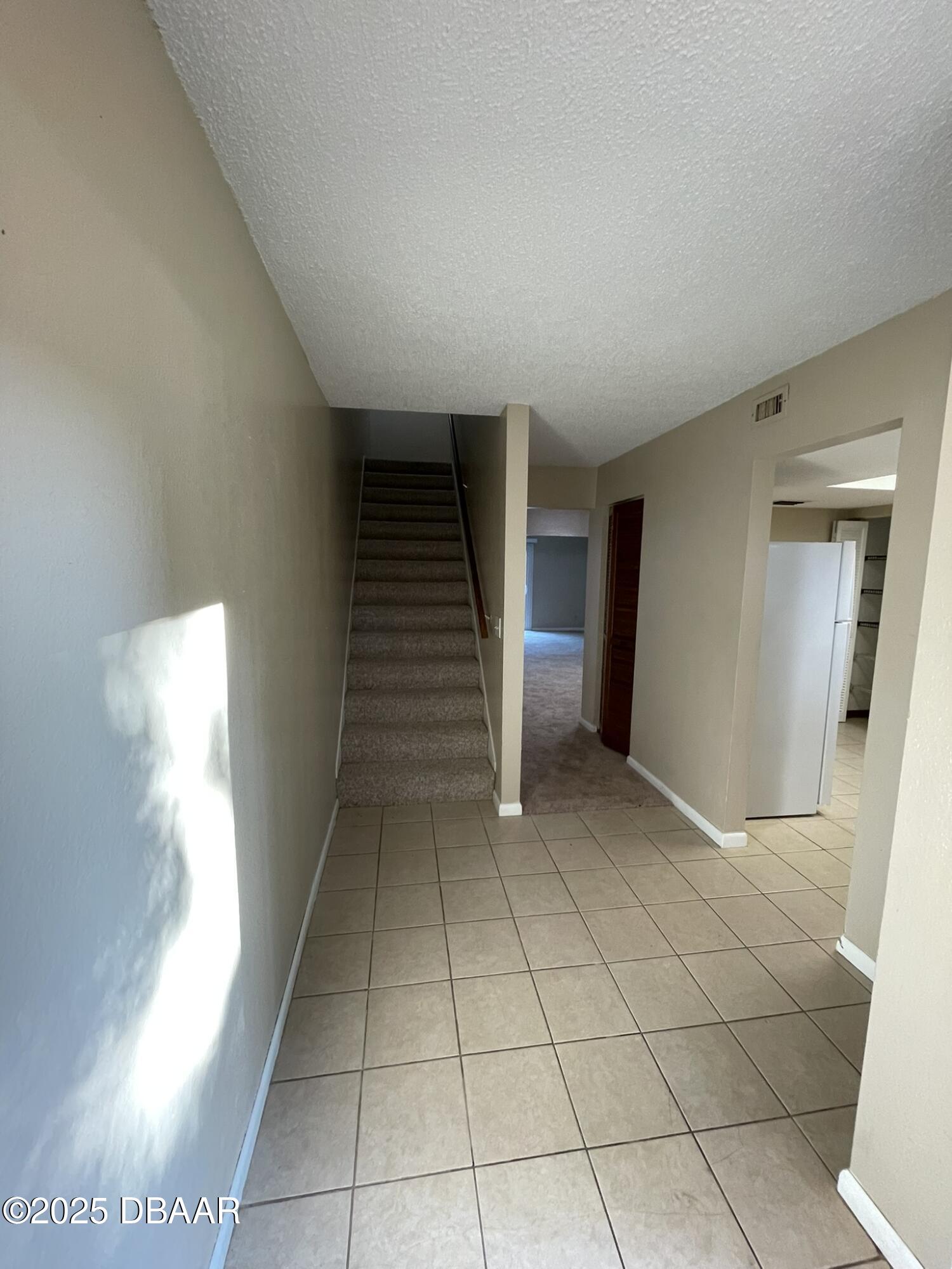 112 Tomoka Meadows Boulevard Ormond Beach, FL 32174 - Photo 14 of 53 a view of an empty room and stairs