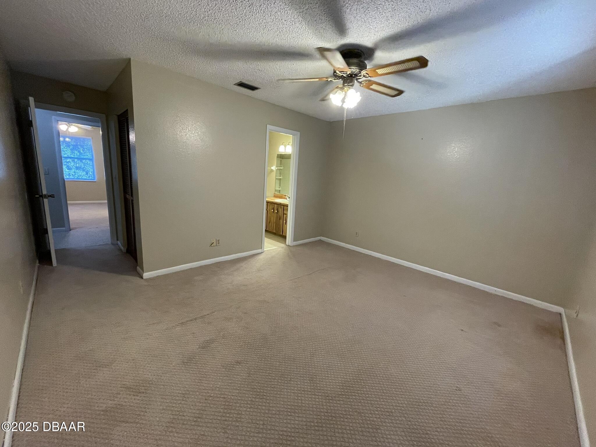112 Tomoka Meadows Boulevard Ormond Beach, FL 32174 - Photo 32 of 53 an empty room with fan and windows