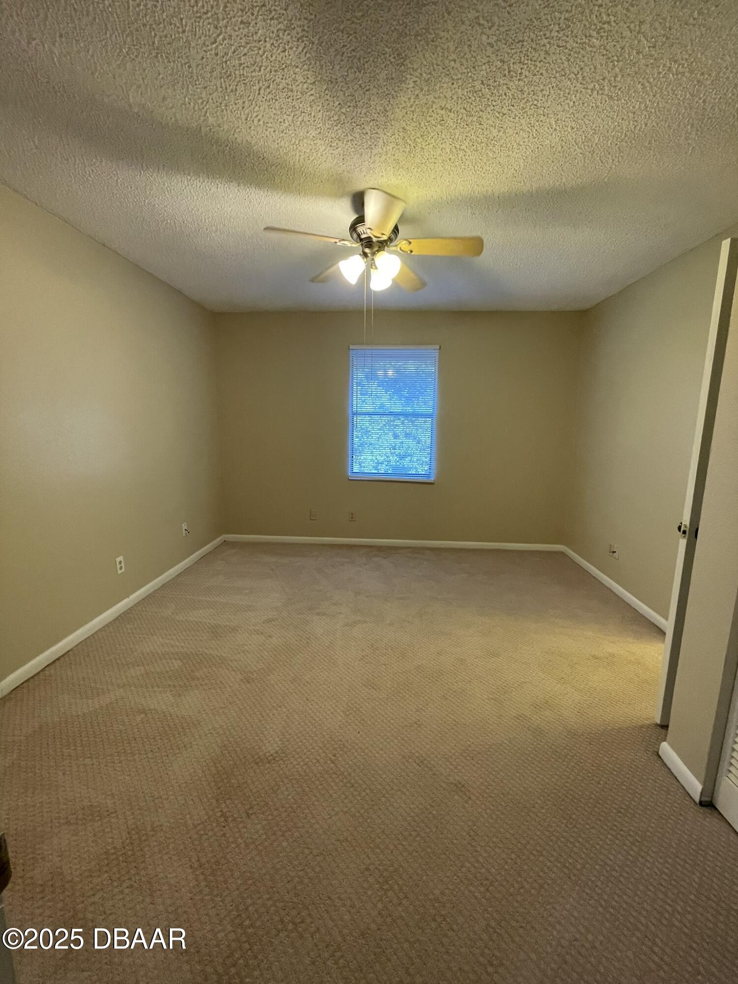 112 Tomoka Meadows Boulevard Ormond Beach, FL 32174 - Photo 39 of 53 an empty room with a ceiling fan and window