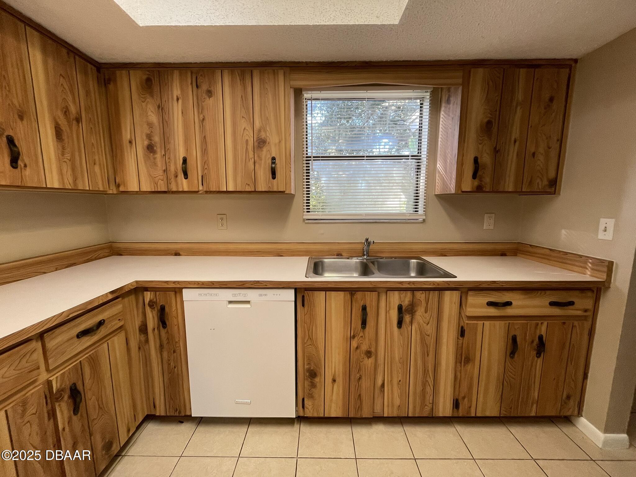 112 Tomoka Meadows Boulevard Ormond Beach, FL 32174 - Photo 6 of 53 a kitchen with a sink a stove and cabinets
