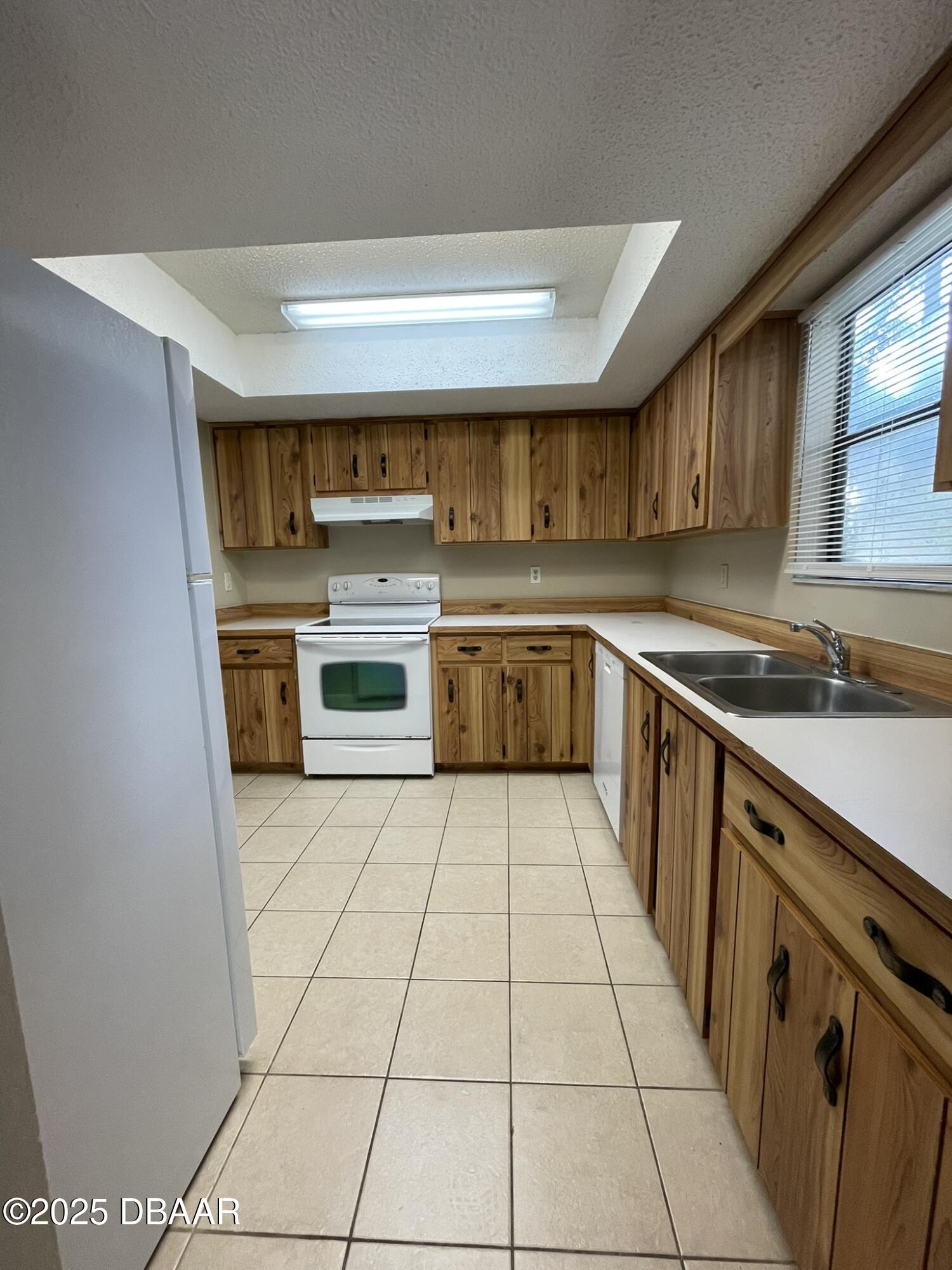 112 Tomoka Meadows Boulevard Ormond Beach, FL 32174 - Photo 7 of 53 a kitchen with stainless steel appliances a stove a sink and a microwave