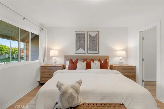 a bedroom with a large bed and a large window