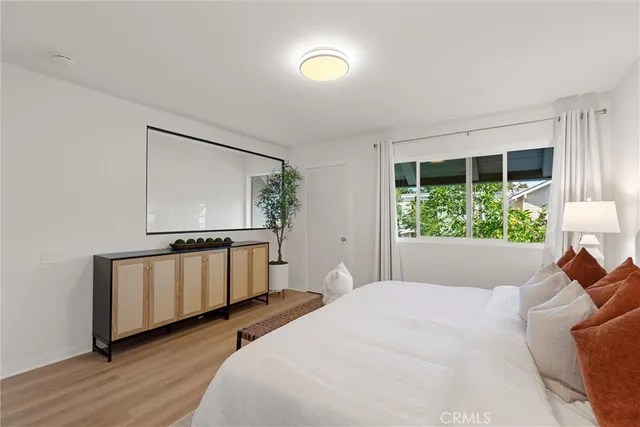 a bedroom with a bed and a window