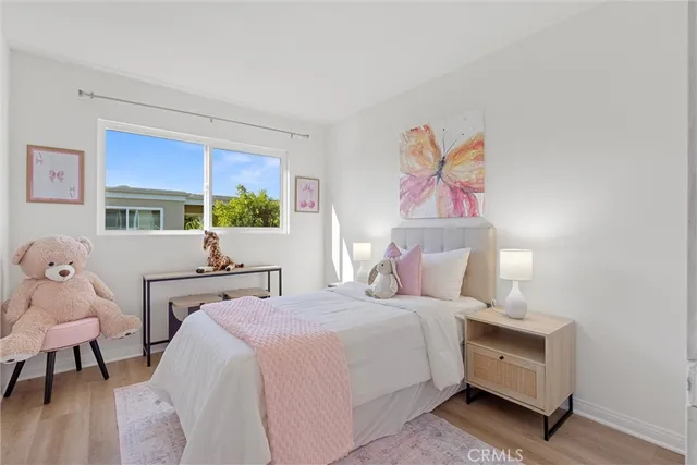 a bed room with a bed and a painting on the wall