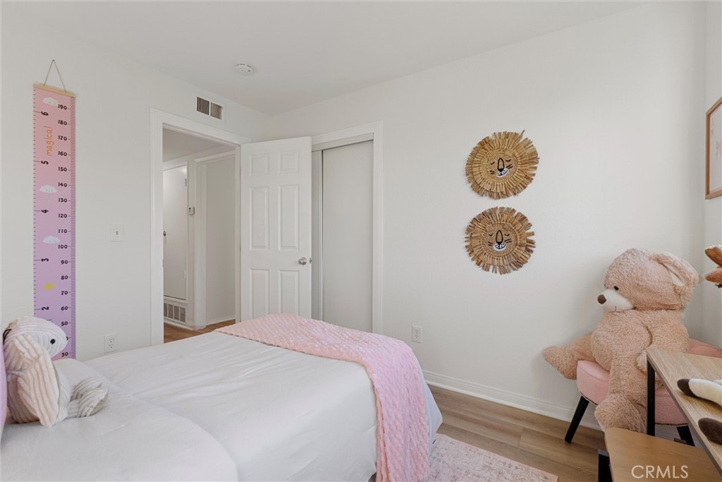 32 Kazan Street Irvine, CA 92604 - Photo 15 of 39 a bedroom with a bed and a chandelier