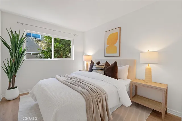 a bed room with a bed and a potted plant