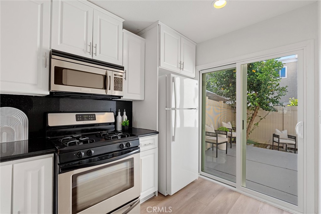 32 Kazan Street Irvine, CA 92604 - Photo 20 of 39 a kitchen with stainless steel appliances granite countertop a stove microwave and refrigerator