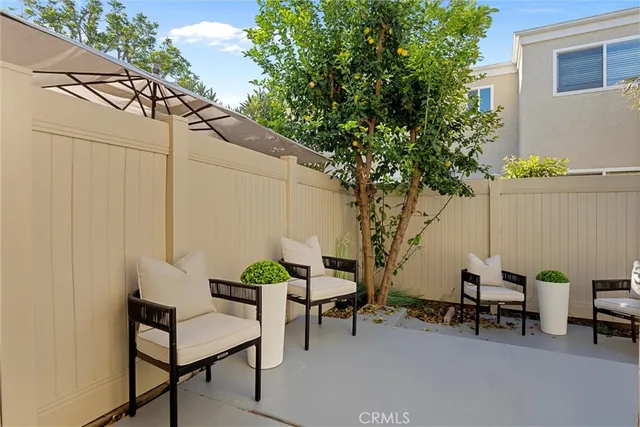 a backyard of a house with table and chairs
