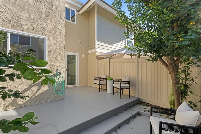 a view of a house with backyard and sitting area