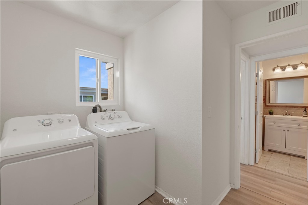 32 Kazan Street Irvine, CA 92604 - Photo 25 of 39 a view of washer and dryer with bathroom in the background