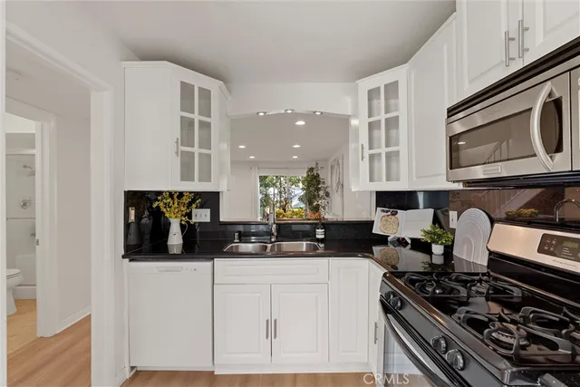 a kitchen with stainless steel appliances a stove a microwave and cabinets