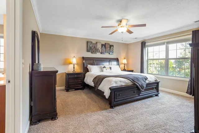 a bedroom with a large bed and a chandelier
