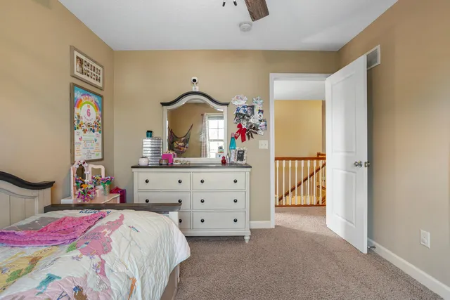 a bedroom with a bed and a dresser