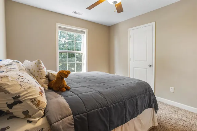 a bedroom with a bed and window