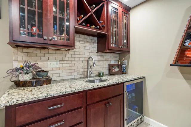 a kitchen with granite countertop a sink a stove and cabinets