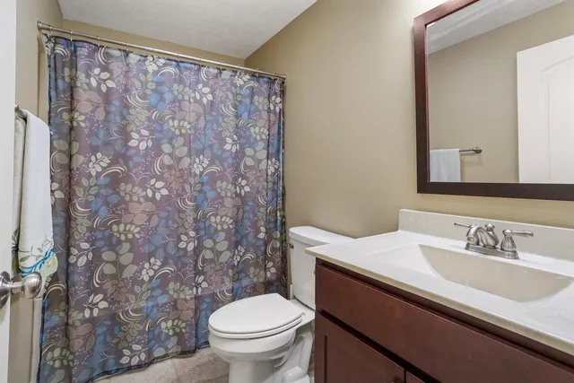a bathroom with a sink toilet and a mirror