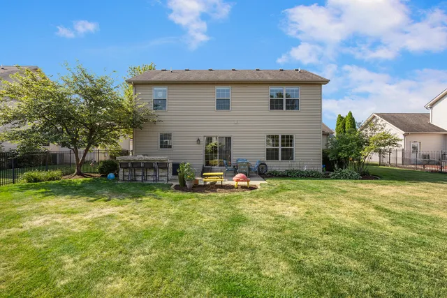 a view of a house with backyard and sitting area
