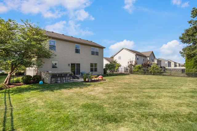 a view of a house with swimming pool and sitting area