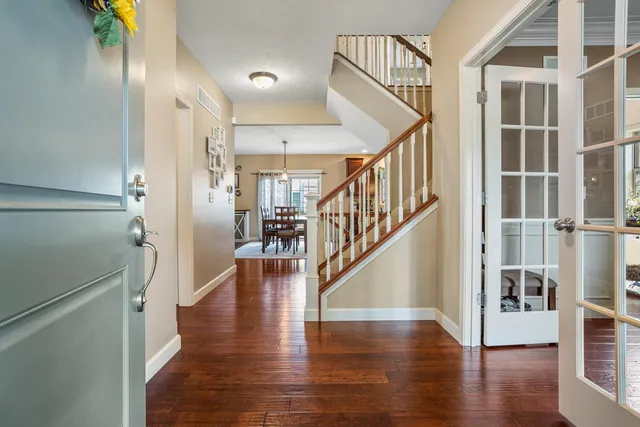 a view of entryway and hall with wooden floor