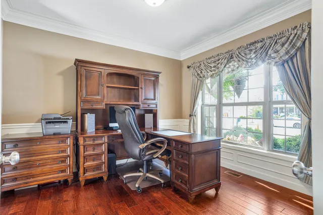 a view of a workspace with furniture and a window