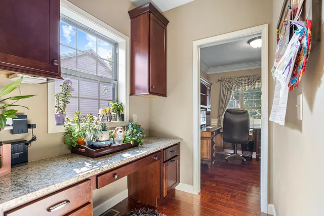 a room with stainless steel appliances granite countertop a sink and a large window