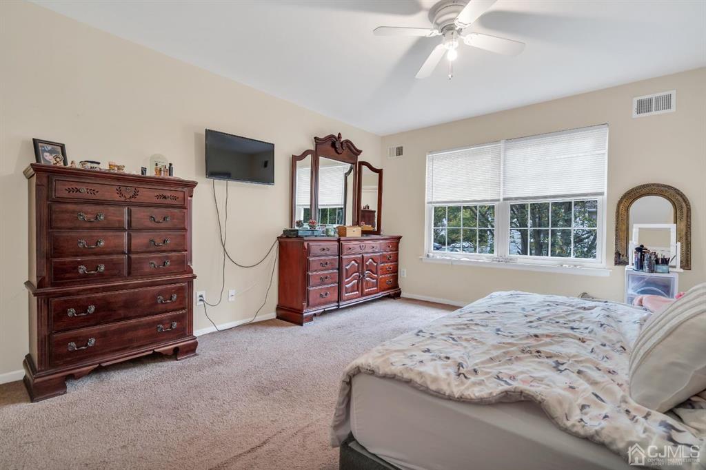 32 Hanover Square Middlesex, NJ 08846 - Photo 17 of 25 a spacious bedroom with a bed a dresser and large window