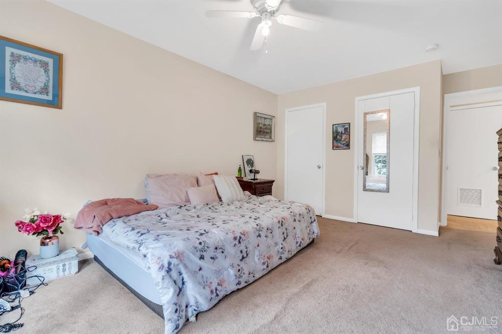 32 Hanover Square Middlesex, NJ 08846 - Photo 18 of 25 a bedroom with a bed and a chandelier