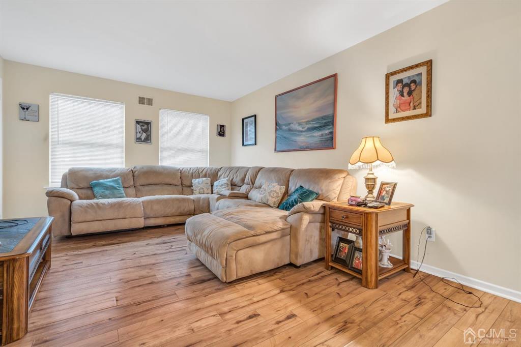32 Hanover Square Middlesex, NJ 08846 - Photo 5 of 25 a living room with furniture and a wooden floor