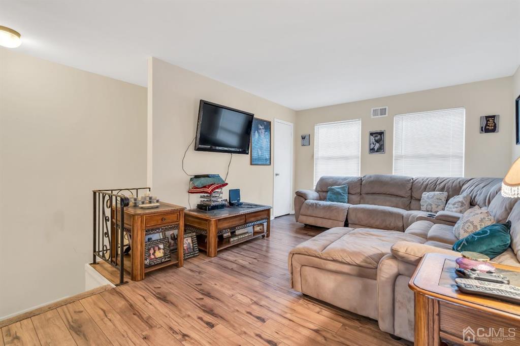 32 Hanover Square Middlesex, NJ 08846 - Photo 7 of 25 a living room with furniture and a flat screen tv