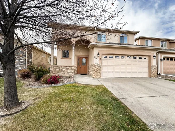 a view of a house with a yard and garage