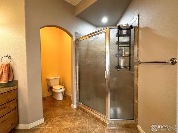 a bathroom with a toilet and a shower