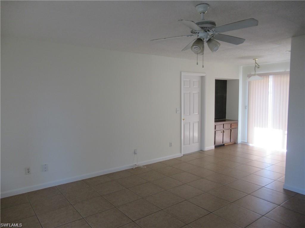 18608 Sebring Road Fort Myers, FL 33967 - Photo 3 of 13 an empty room with a empty space and a ceiling fan