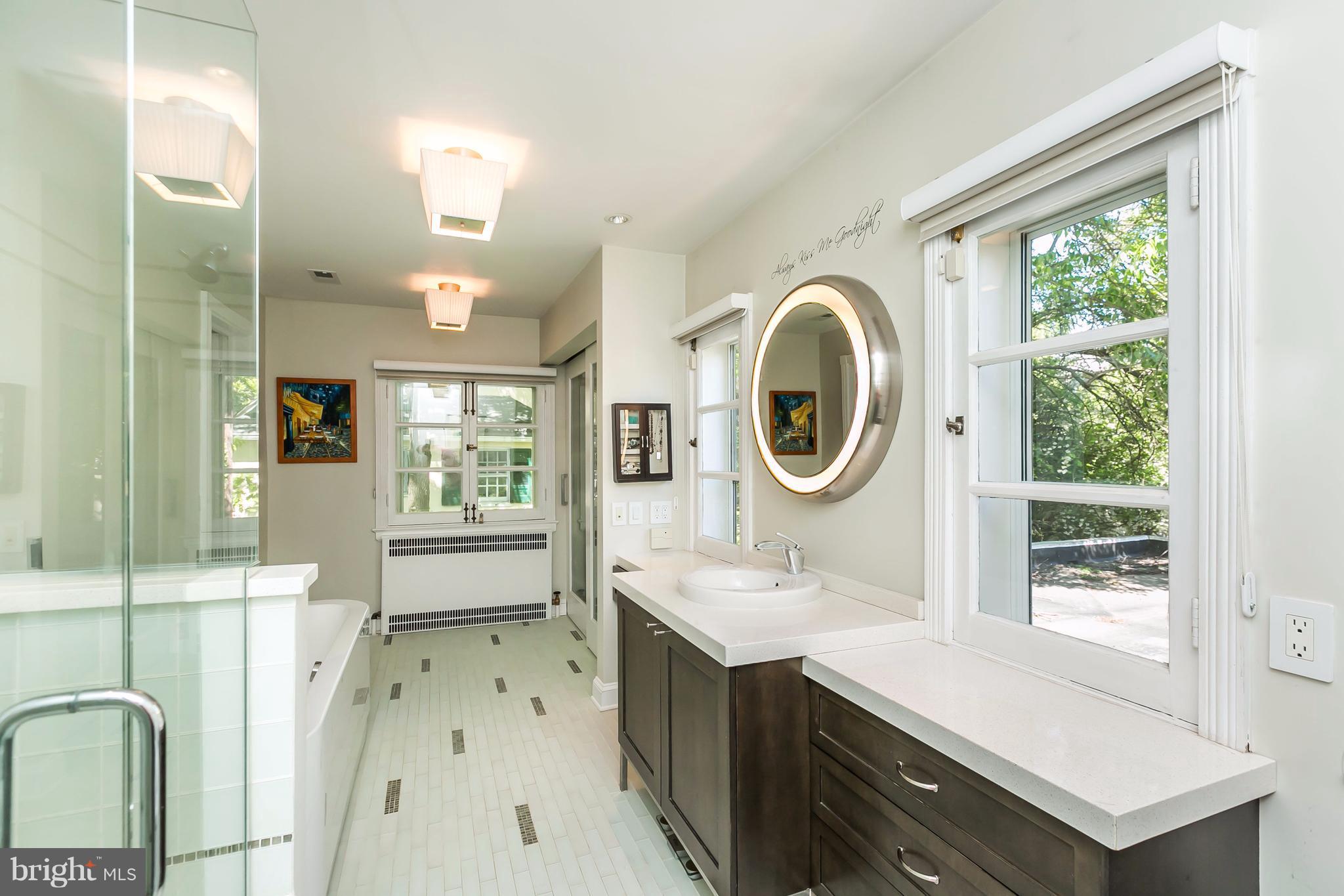 2 St Johns Road Baltimore, MD 21210 - Photo 15 of 30 a bathroom with a sink a mirror a bathtub and next to a window