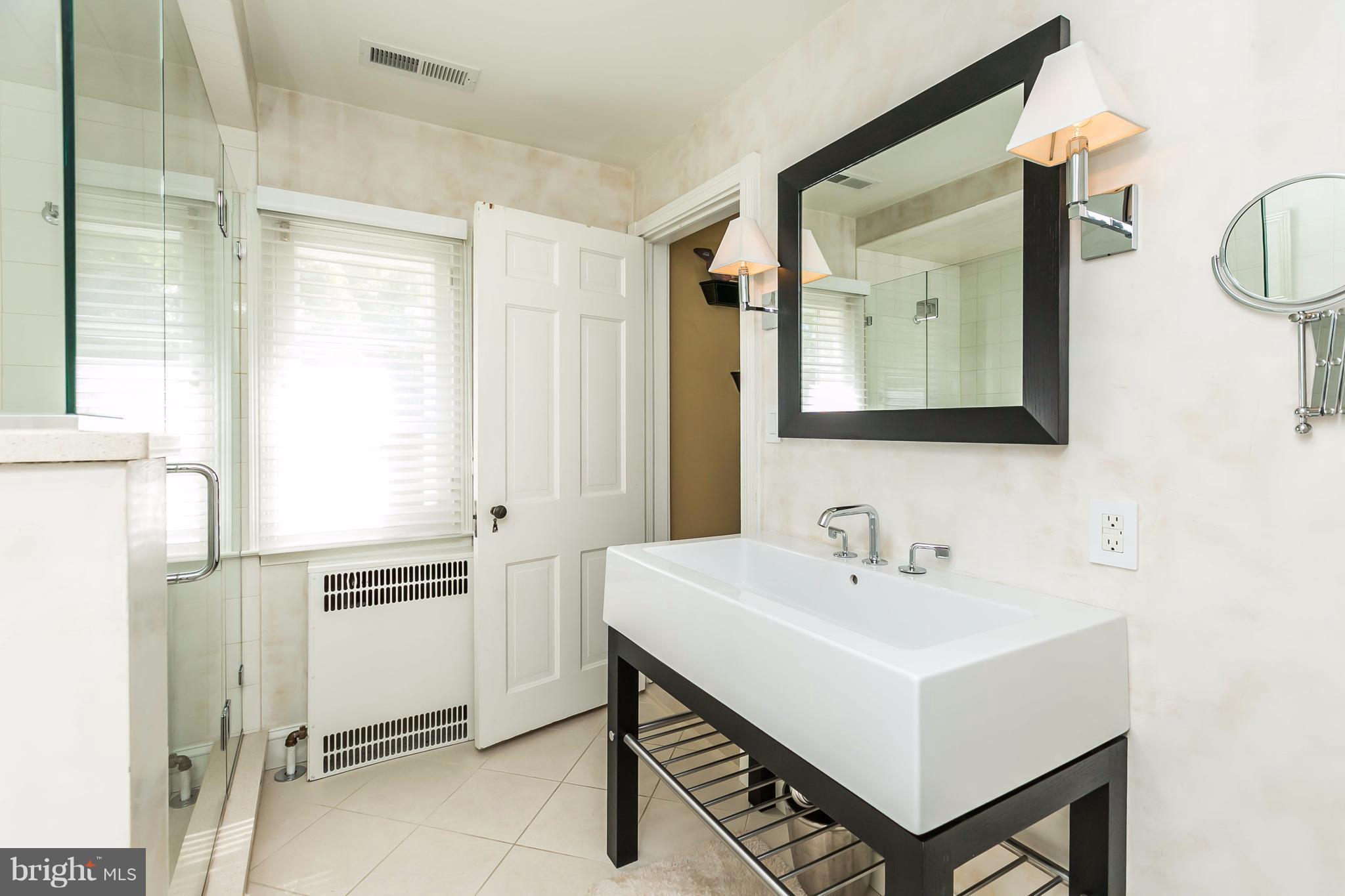 2 St Johns Road Baltimore, MD 21210 - Photo 20 of 30 a white house with sink and mirror