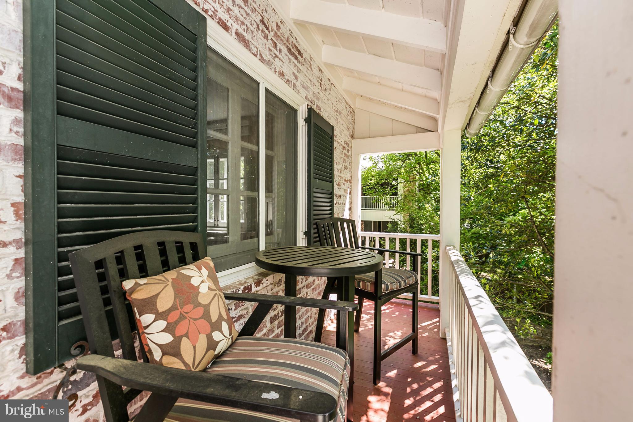2 St Johns Road Baltimore, MD 21210 - Photo 23 of 30 a view of a patio with table and chairs with wooden floor and fence