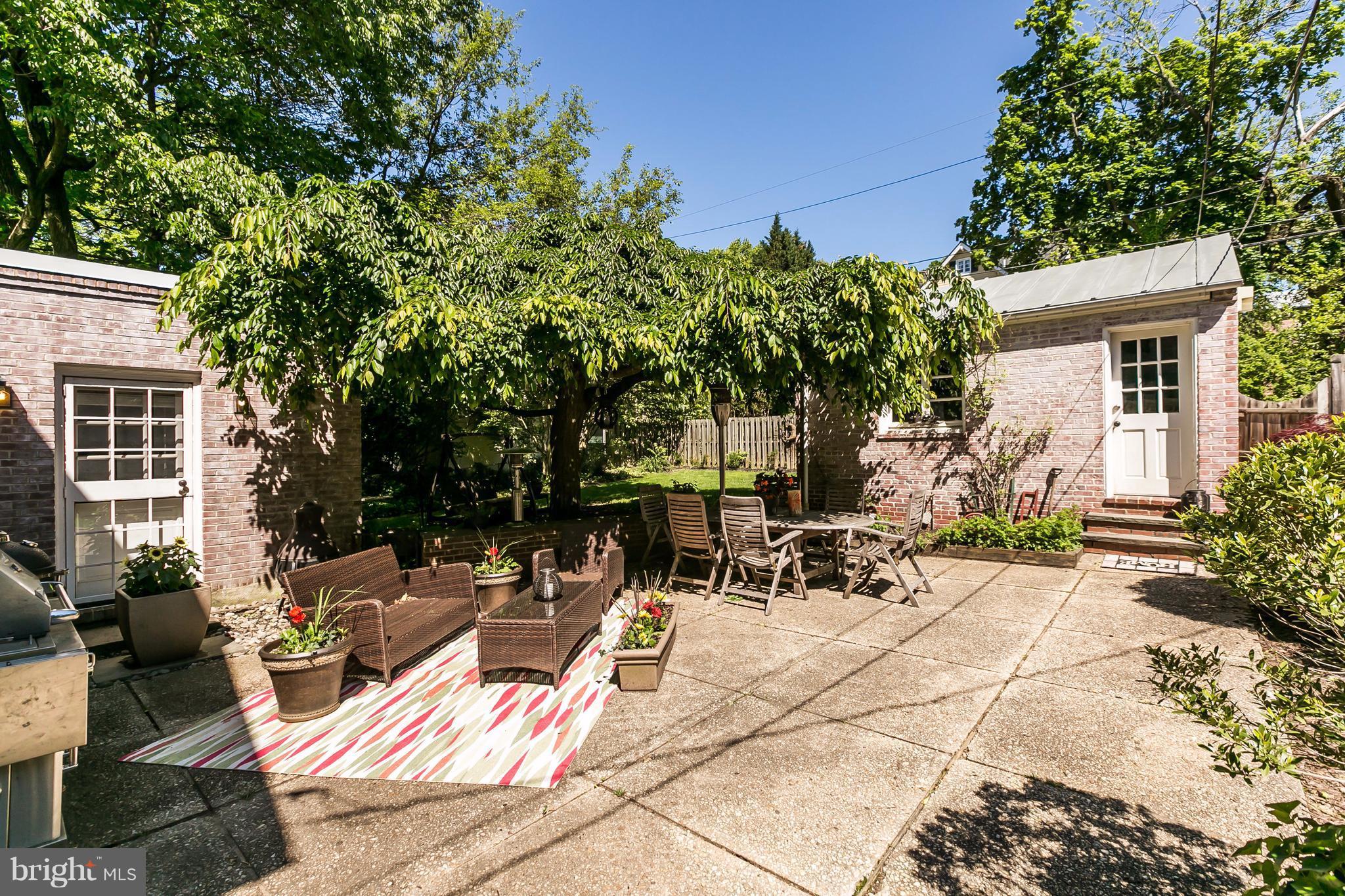 2 St Johns Road Baltimore, MD 21210 - Photo 27 of 30 a view of a patio with table and chairs potted plants and a large tree