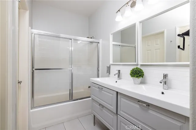 a bathroom with a bathtub sink vanity and mirror