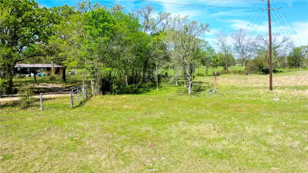 a swimming pool with outdoor seating and yard