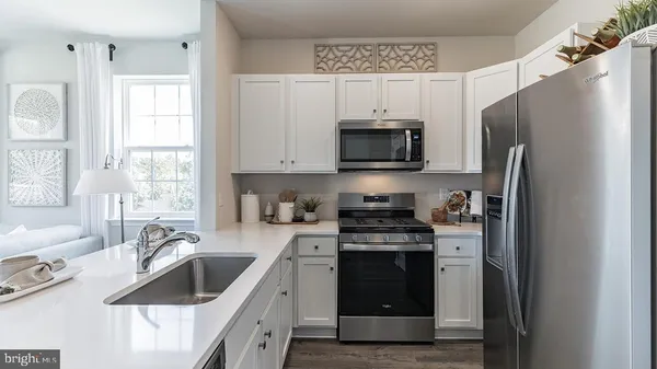 a kitchen with a sink stove and refrigerator