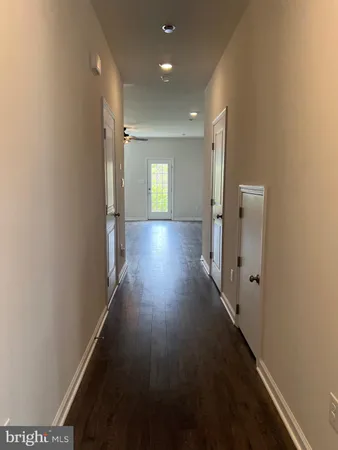 view of a hallway with wooden floor