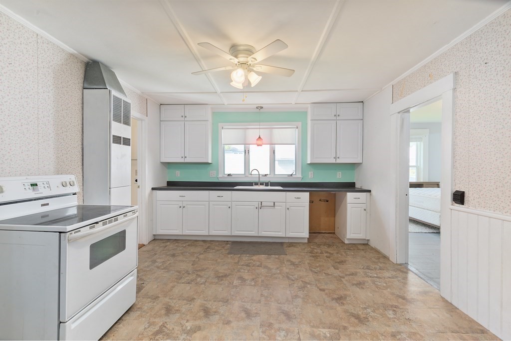 16 Silver Street Haverhill, MA 01832 - Photo 11 of 16 a kitchen with granite countertop white cabinets and white appliances