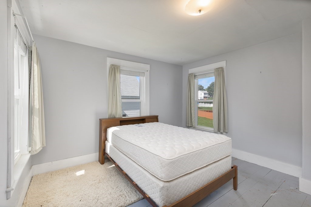 16 Silver Street Haverhill, MA 01832 - Photo 13 of 16 a bed sitting in a spacious bedroom next to a window