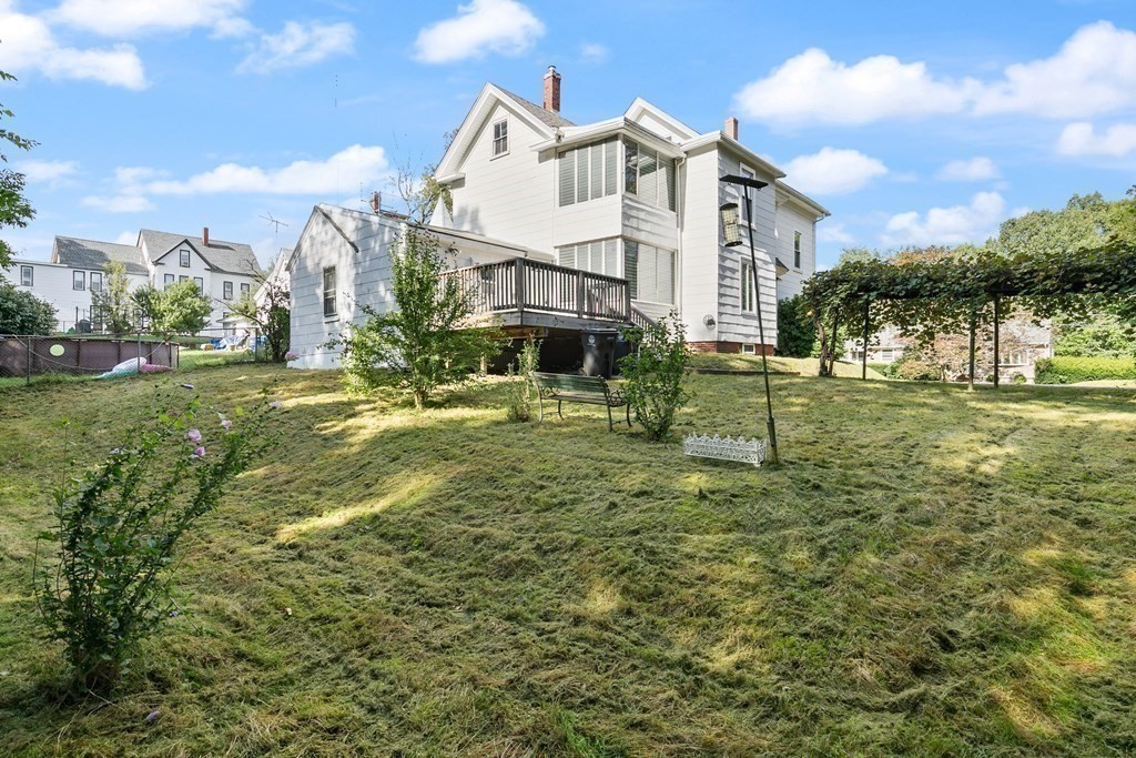 16 Silver Street Haverhill, MA 01832 - Photo 3 of 16 a view of a white house with a big yard and potted plants