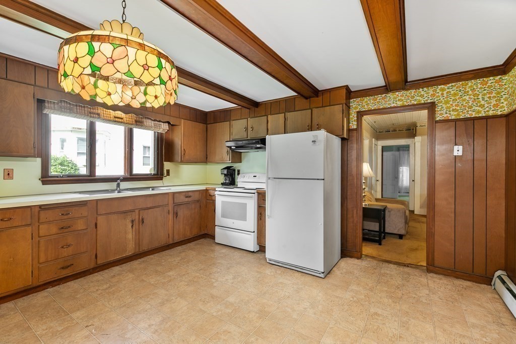 16 Silver Street Haverhill, MA 01832 - Photo 5 of 16 a kitchen with cabinets a washer and dryer