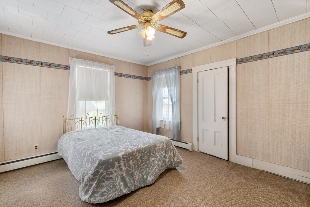 16 Silver Street Haverhill, MA 01832 - Photo 8 of 16 a bedroom with a bed and a chandelier
