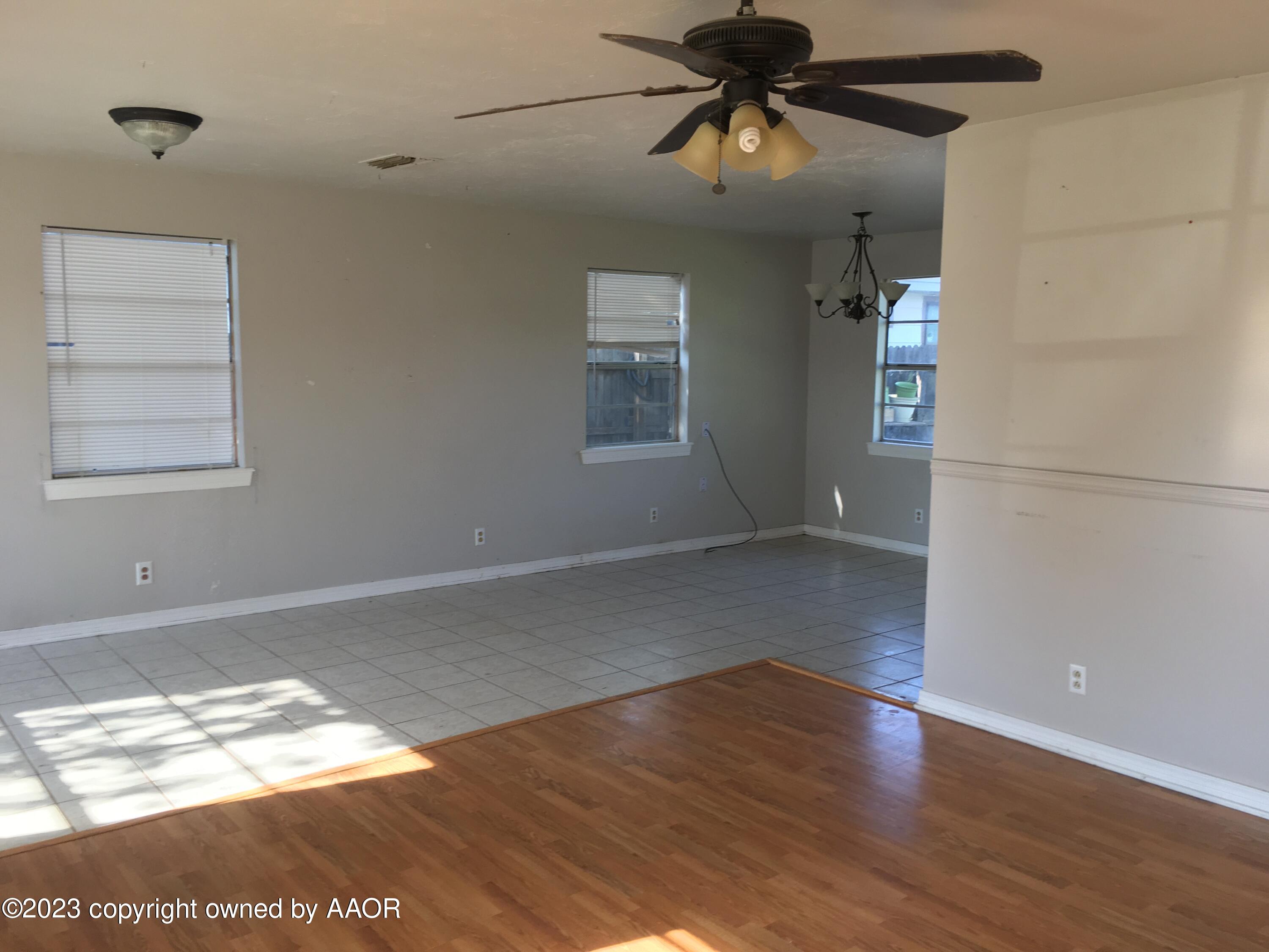 4415 South Hayden Street Amarillo, TX 79110 - Photo 3 of 7 a view of empty room with wooden floor and fan