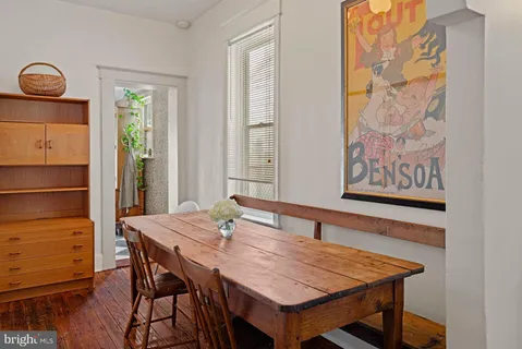 a dining room with a wooden table and chairs