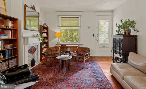 a living room with furniture and a book shelf
